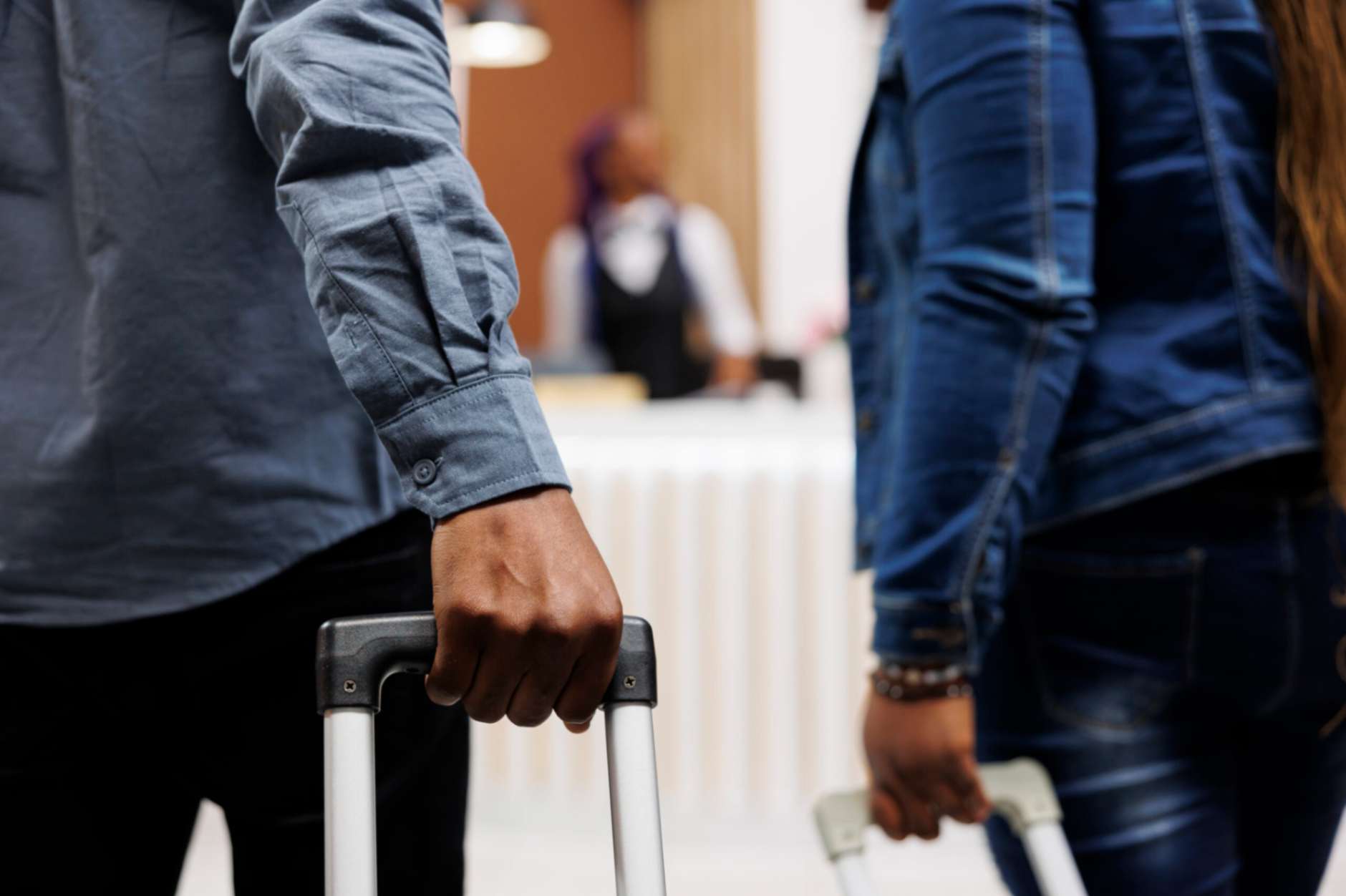 Couple pulling luggage in hotel