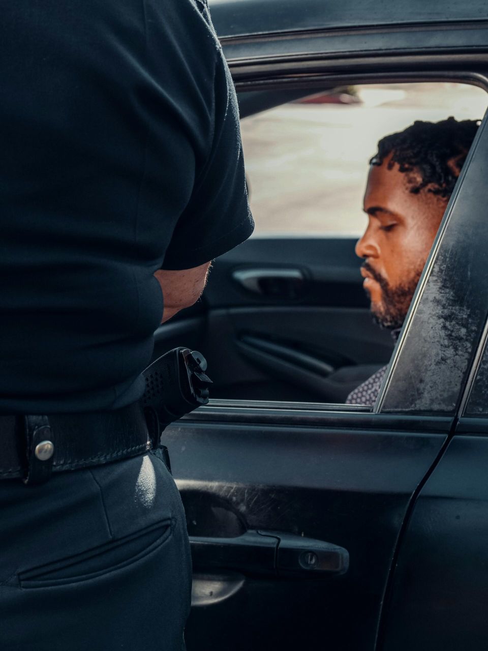Police Officer Standing Beside a Car