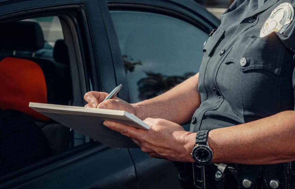 Police Writing on a Notebook