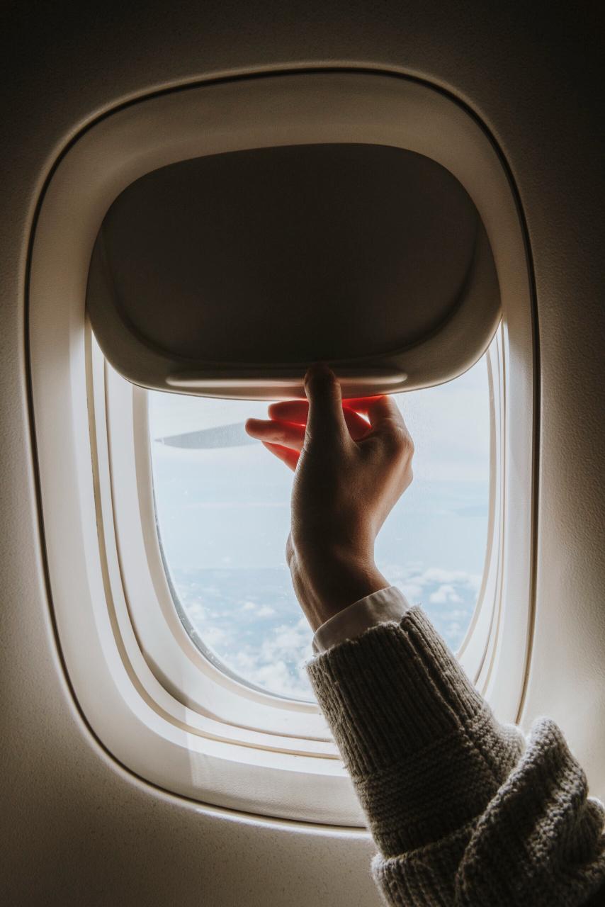 Woman opening a window shade